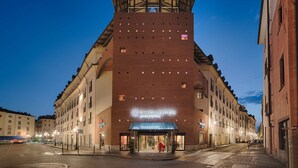 A hotel with a prominent 17th Collection sign, a central atrium, and a brick facade. - NH Collection Torino Santo Stefano (Turin)