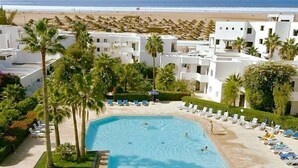 A resort with a swimming pool, beach view, and white buildings. - Royal Decameron Tafoukt Beach Resort & Spa - All Inclusive (Agadir)