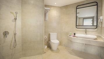A modern bathroom with a shower, toilet, and sink.