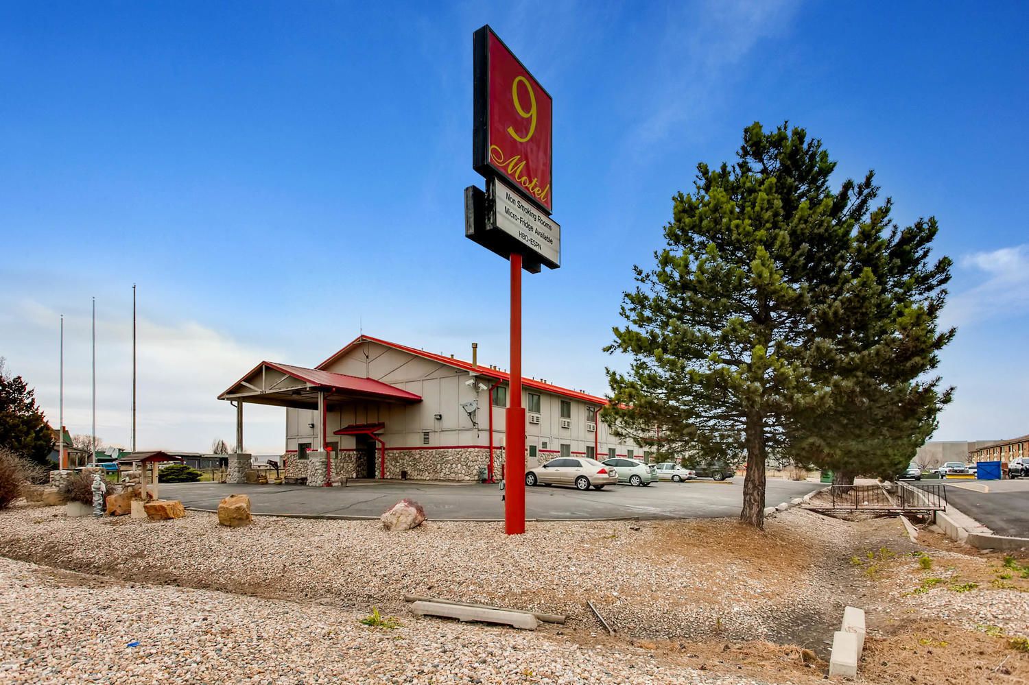 A motel with a red roof and a sign indicating it is number 9.