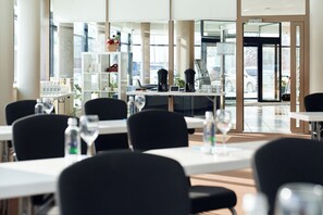 A modern hotel lobby with a seating area, a coffee station, and a view of the parking lot. - Green Park Hotel Klaipeda (Klaipeda)