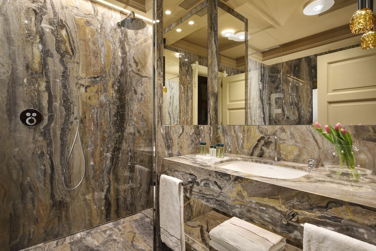 designer toiletries, hair dryer, bathrobes, slippers