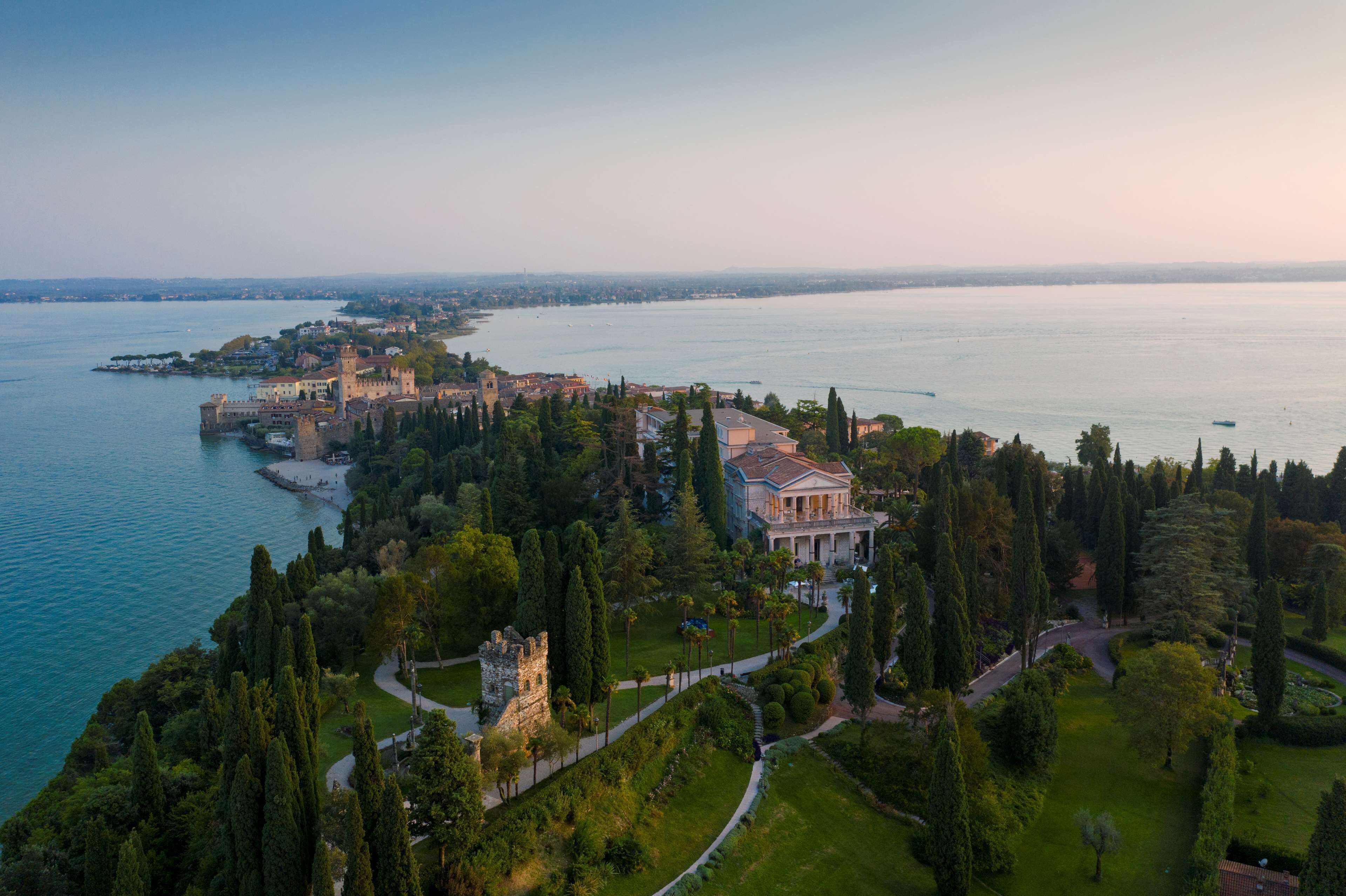 A coastal property with a castle, manicured gardens, and a view of the sea.