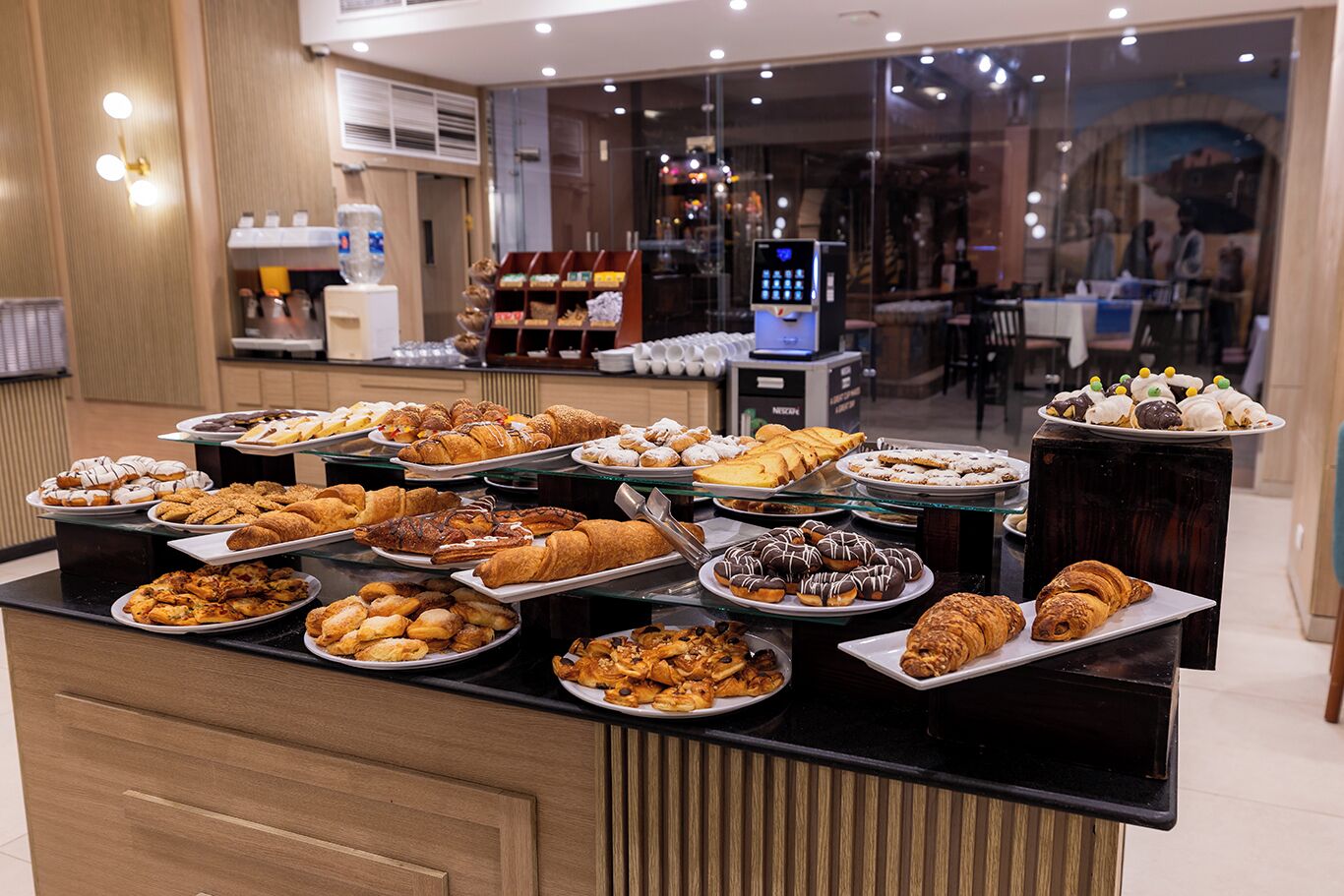 A buffet with various pastries and desserts.