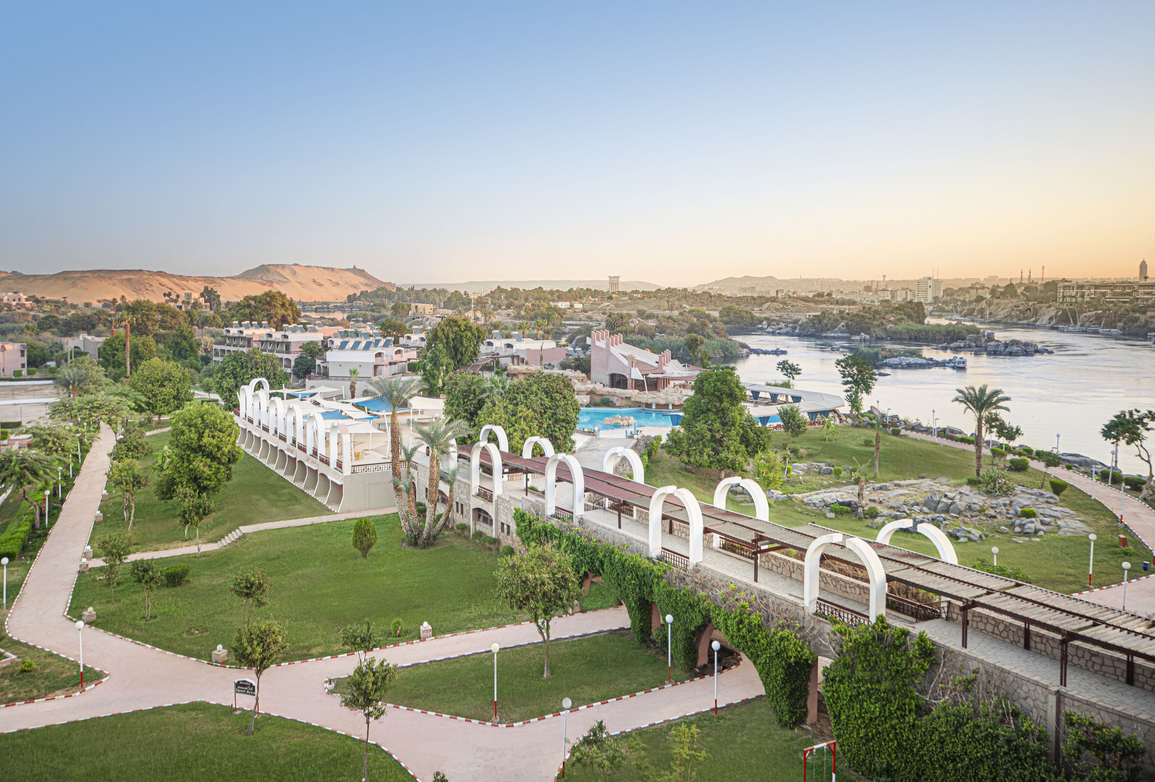 A coastal resort with a central pathway, beach access, and a view of the sea.