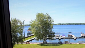 A lakeside view with docked boats, a gazebo, and a picnic area. - The Stonefence Resort (Ogdensburg)
