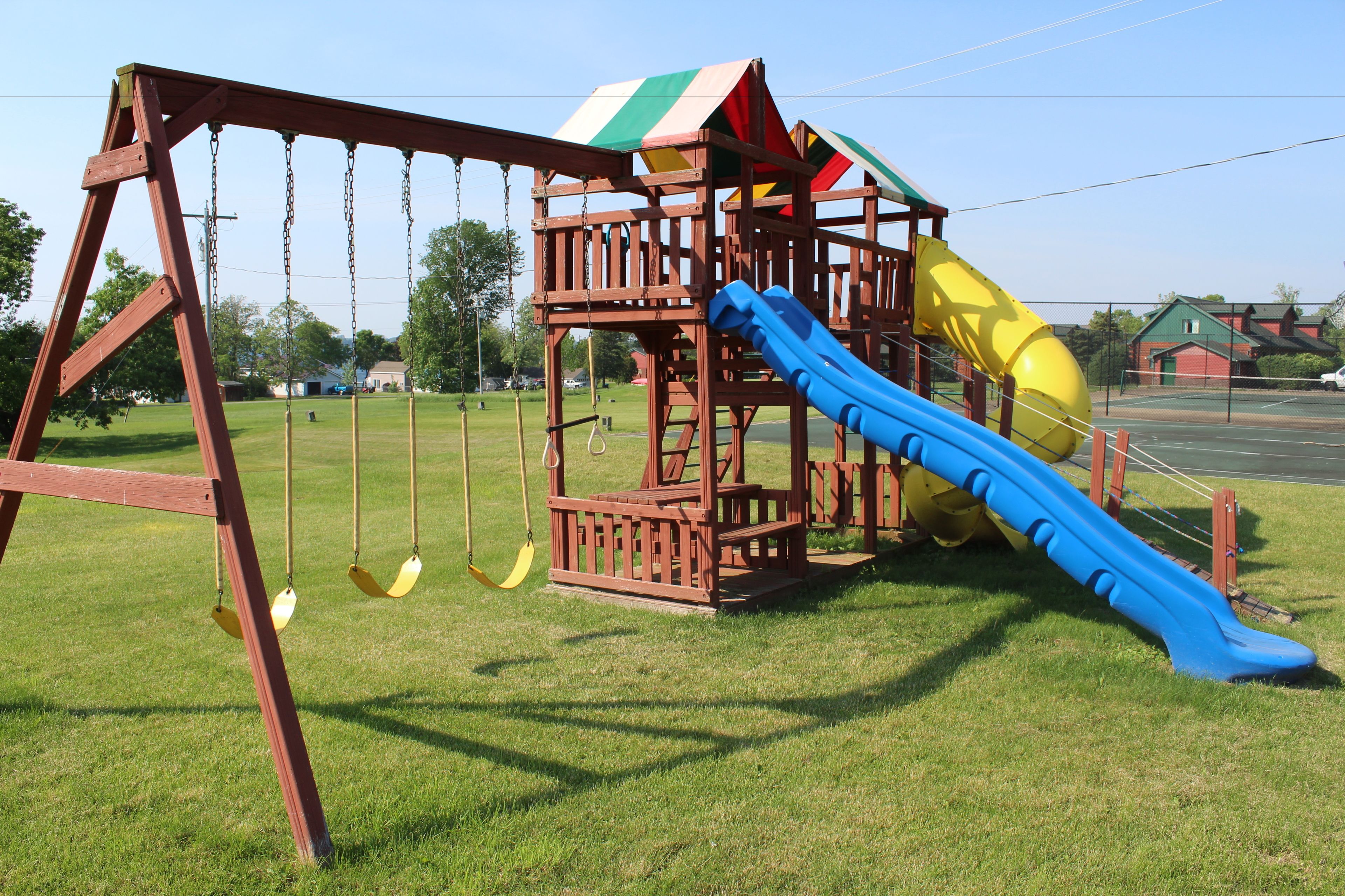 A playground with a swing set and a slide.