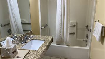 A bathroom with a sink, mirror, shower, and bathtub.