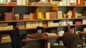 A library with bookshelves, a table, and a chair.