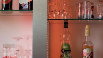 A bar area with shelves of liquor bottles and glasses.
