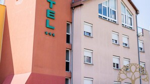 A hotel building with a prominent 'HOTEL' sign on the side. - Adonis Gapotel (Gap)