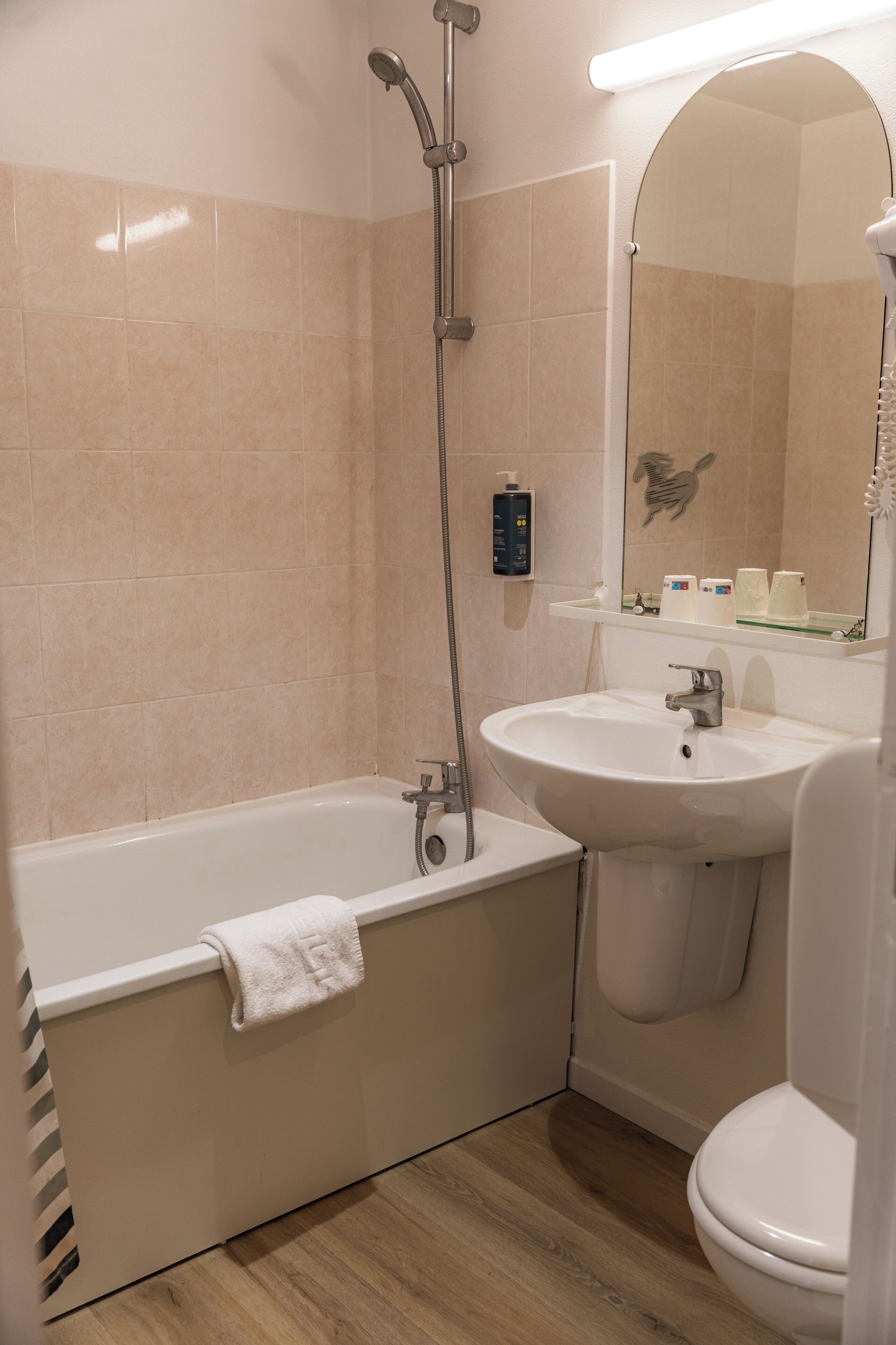 A bathroom with a bathtub, sink, and toilet.