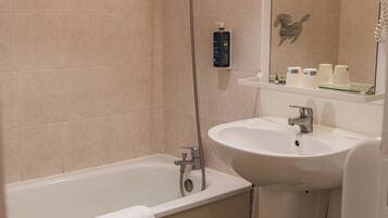 A bathroom with a bathtub, sink, and toilet.