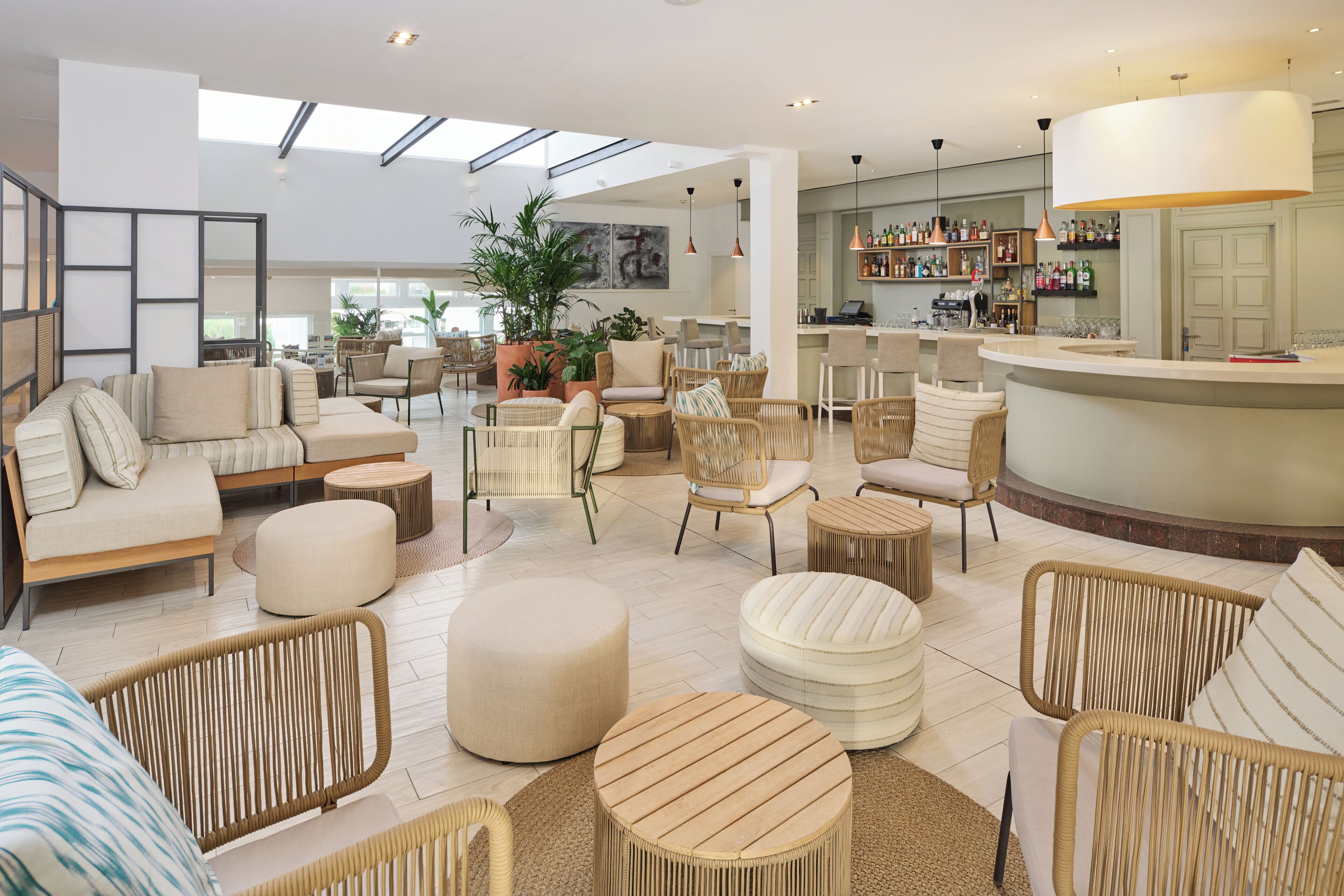 A spacious lounge area with multiple seating options including sofas, chairs, and ottomans.