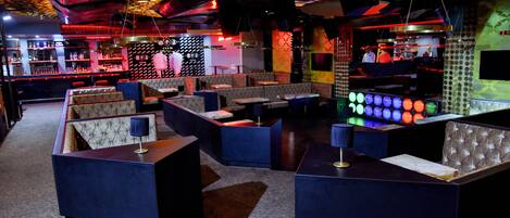 A bar area with seating and a bar counter.