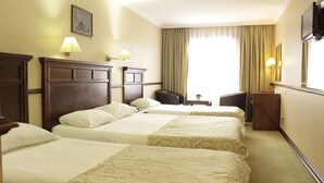A hotel room with three beds, a desk, a chair, and a television. - Topkapi Inter Istanbul Hotel (Istanbul)