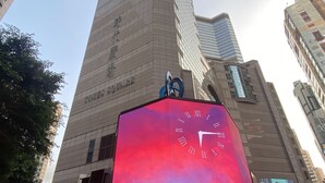 A tall building with a clock on top and a sign that reads "Times Square." - Holiday Inn Express Causeway Bay Hong Kong by IHG (Hong Kong)