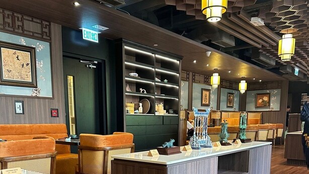 A modern restaurant interior with wooden furniture, a central counter, and hexagonal ceiling lights. - Holiday Inn Express Causeway Bay Hong Kong by IHG (Hong Kong)