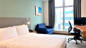 A hotel room with a large bed, a desk with a chair, a television, and a window with curtains. - Holiday Inn Express Causeway Bay Hong Kong by IHG (Hong Kong)