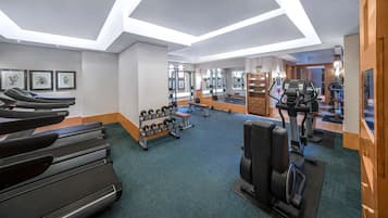 A modern gym with treadmills, dumbbells, and exercise equipment.