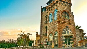 A historic stone building with arched windows and a balcony, labeled "Hotel Villa." - HOTEL VILLA CARLOTTA (Taormina)