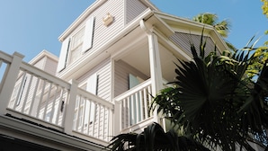 A two-story house with a balcony and a small porch. - Fitch Lodge - Key West Historic Inns (Key West)