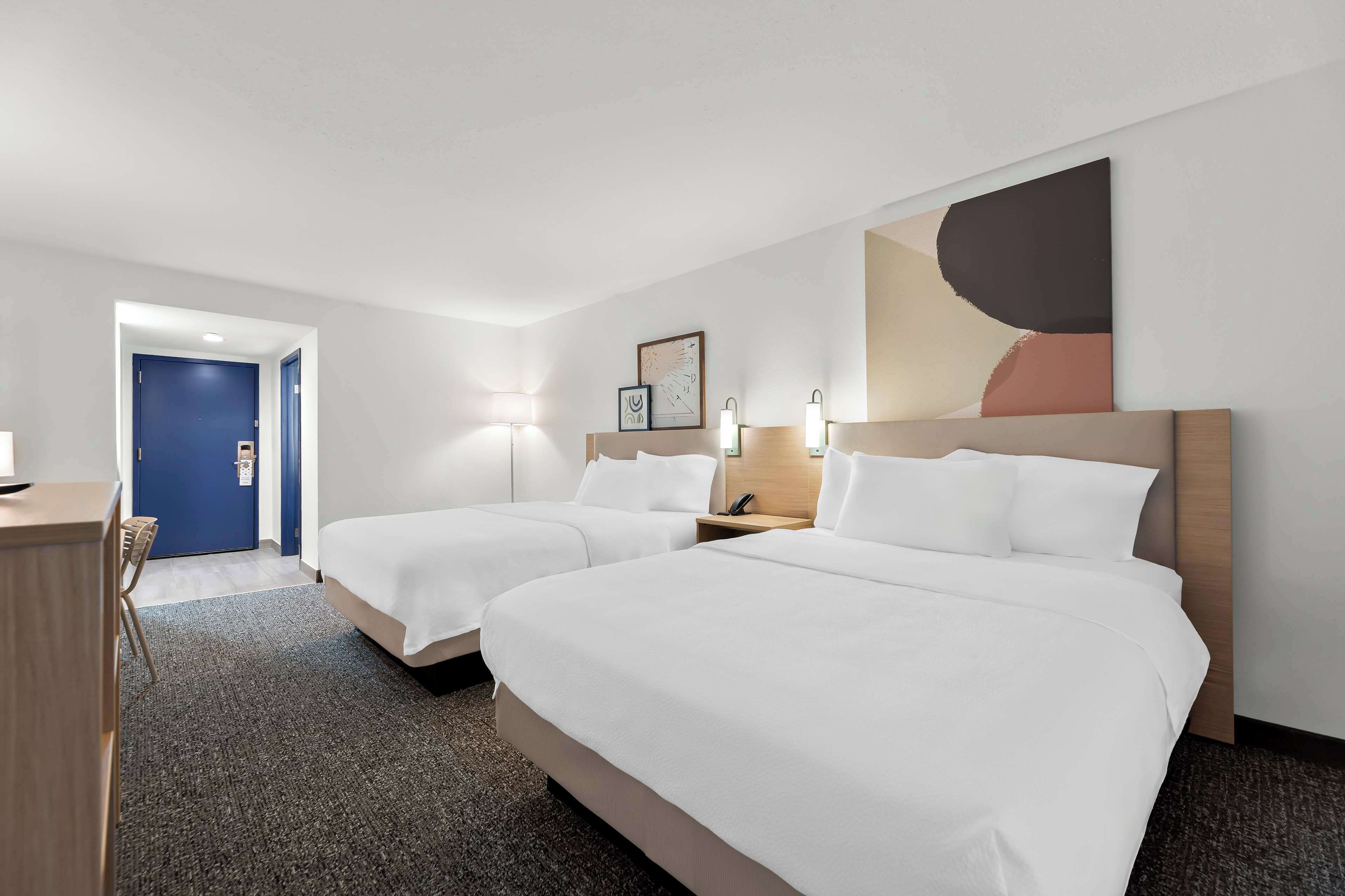 room, 2 queen beds | in-room safe, desk, iron/ironing board, free cots/infant beds