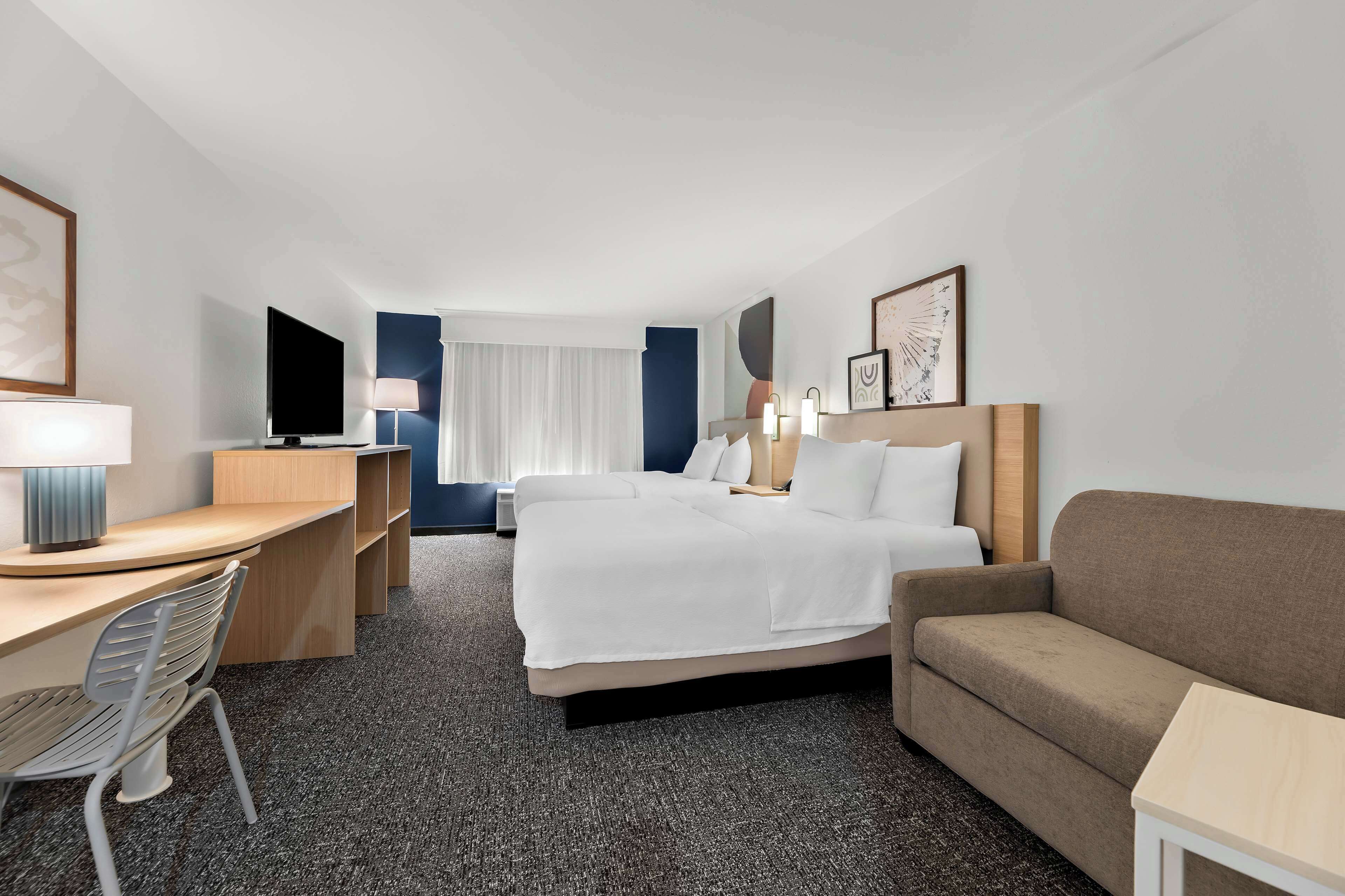 room, multiple beds | living area | flat-screen tv