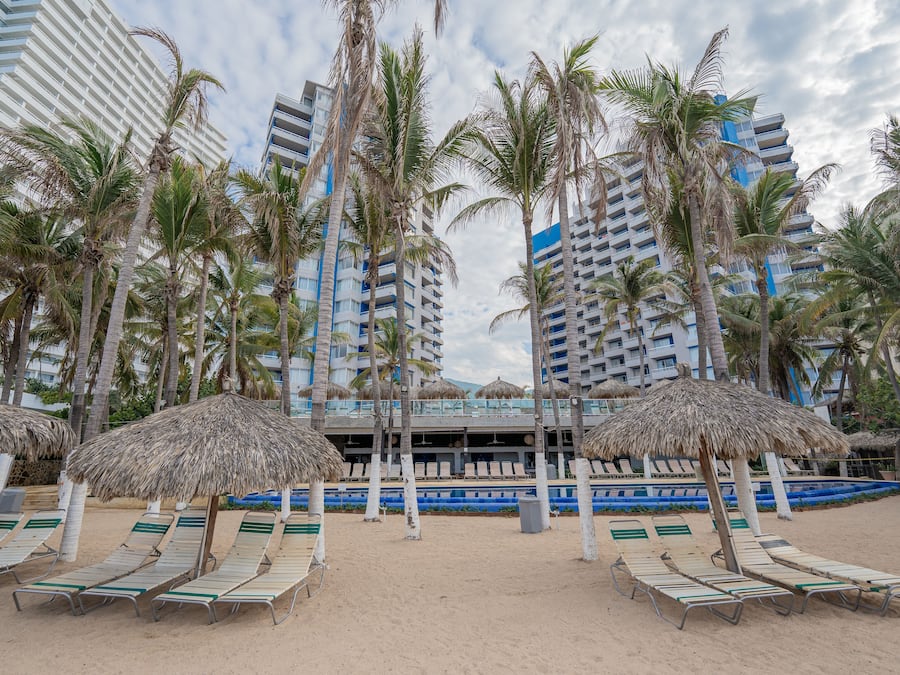 On the beach, white sand, sun loungers, beach umbrellas