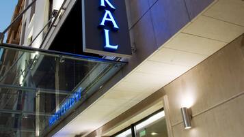 A hotel sign with the name "HOTEL CENTRAL" illuminated in blue.