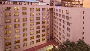 A hotel with multiple floors, a rooftop pool, and a courtyard with a swimming pool. - The Chancery Pavilion (Bengaluru)