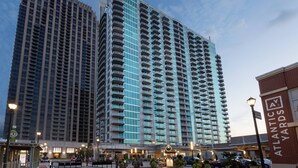 A high-rise hotel with a modern design, featuring multiple balconies and a prominent entrance. - Twelve Midtown, Autograph Collection (Atlanta)