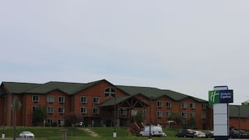 A Holiday Inn Express hotel with a brick facade, multiple windows, and a green roof.