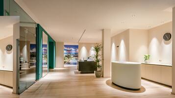Relax in the hotel's serene atmosphere, surrounded by a scenic mountain landscape and a unique ceiling design.