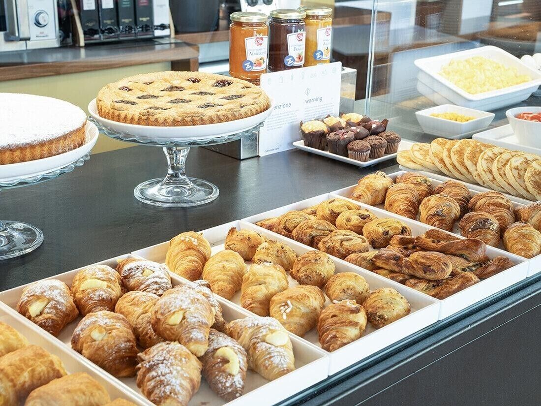 A bakery display with various pastries and desserts.