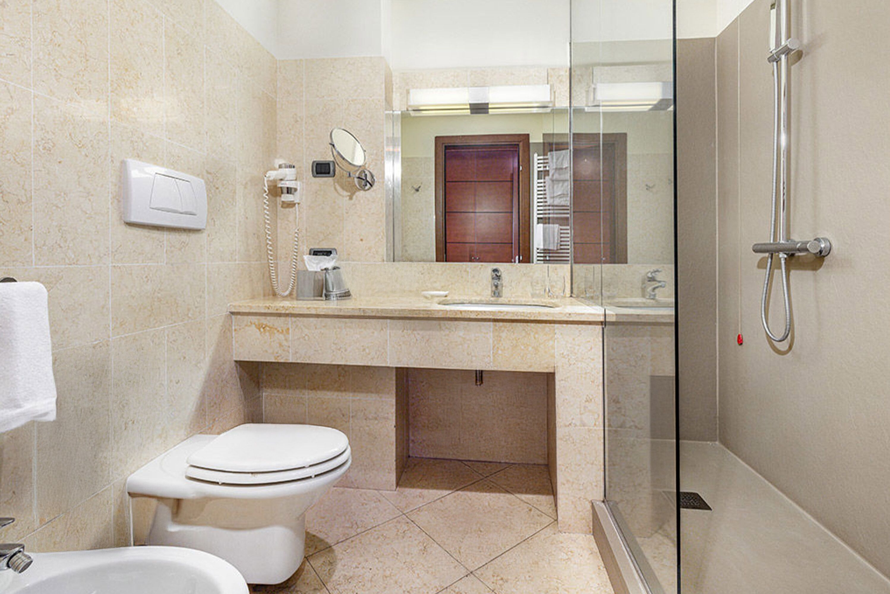 designer toiletries, hair dryer, slippers, bidet