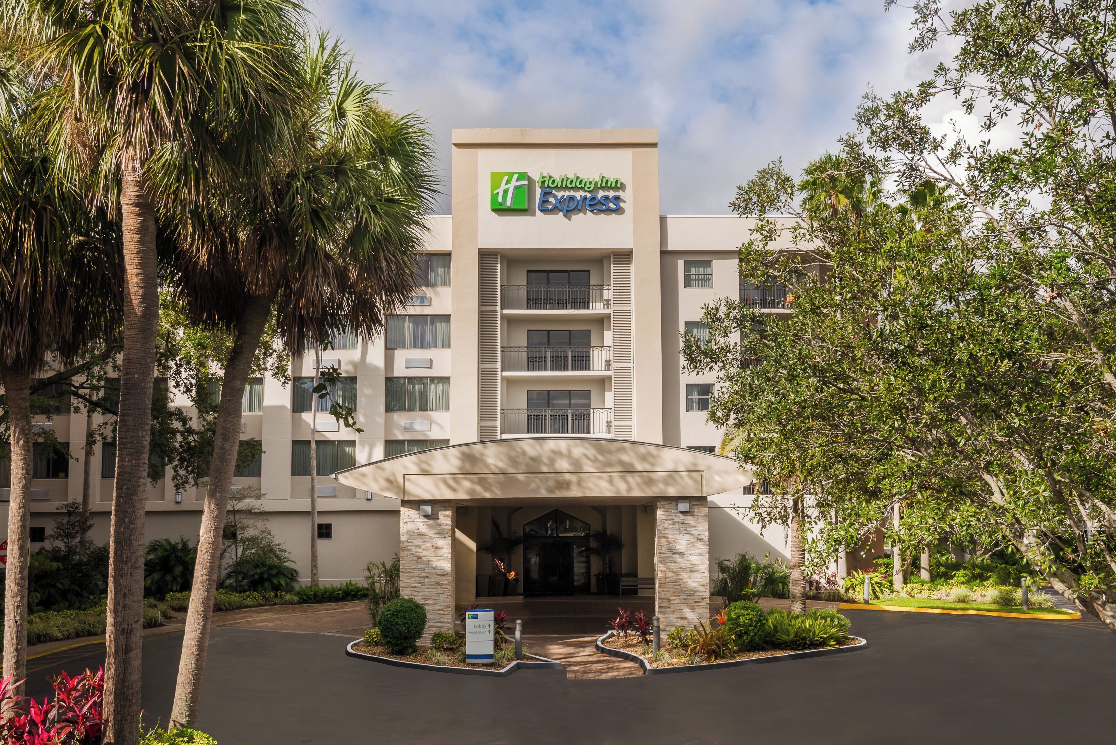 A hotel with a modern entrance, a lobby area, and a sign indicating the hotel's name.