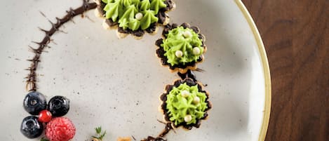 A dessert plate with a decorative arrangement of berries and chocolate.