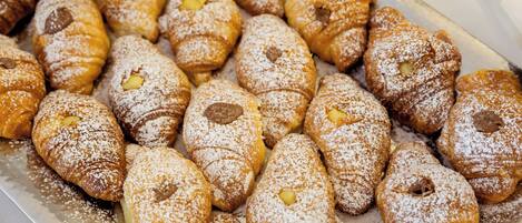 A tray of pastries dusted with powdered sugar.
