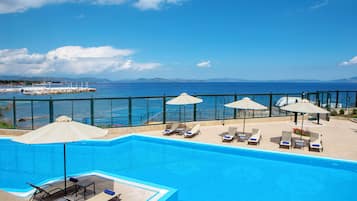 Seasonal outdoor pool, open 10 AM to 6:30 PM, pool umbrellas