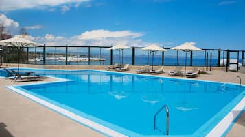Seasonal outdoor pool, open 10 AM to 6:30 PM, pool umbrellas