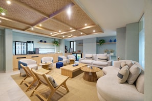 A modern living area with a kitchen, seating arrangements, and a ceiling with recessed lighting. - AluaSoul Palma - Adults Only (Palma de Mallorca)