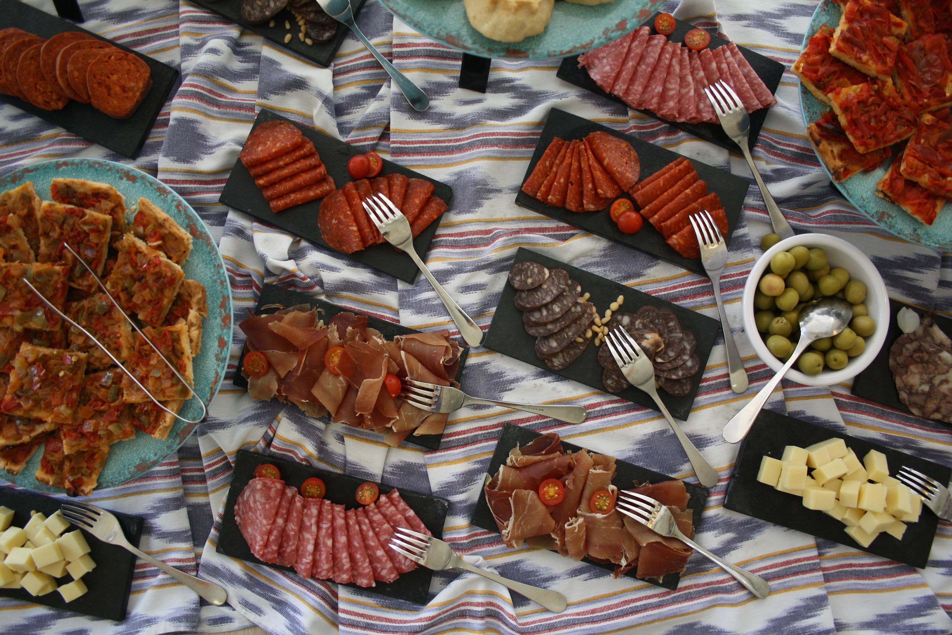 A table with various food items and utensils.