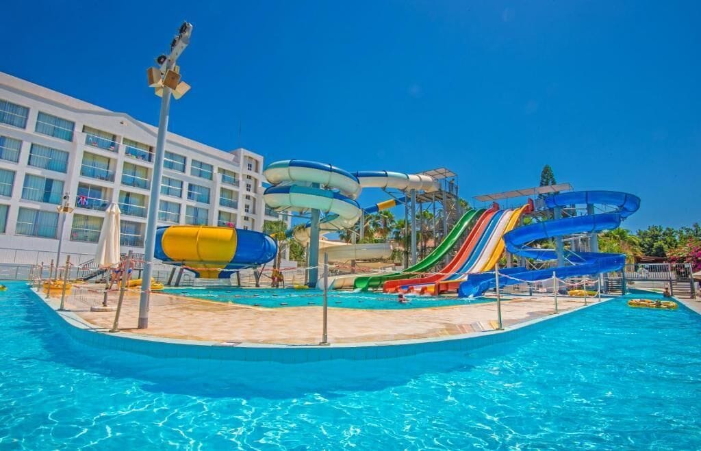 A water park with multiple slides and a pool.