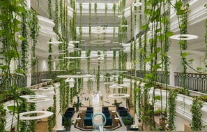 A multi-level atrium with hanging plants, circular platforms, and seating areas. - Anastasia Waterpark Beach Resort (Paralimni)