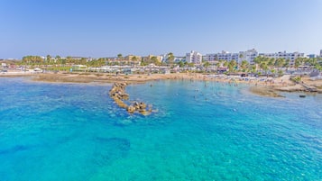 White sand, sun loungers, beach umbrellas, beach towels