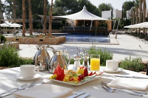 Enjoy a leisurely breakfast near the pool with a view.