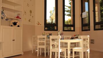 Enjoy meals with family and friends at the large dining table surrounded by four chairs.