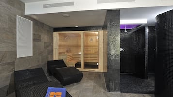 Relax in a serene spa area with a sauna, comfortable seating, and a warm atmosphere.