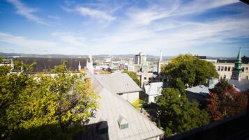 A cityscape with buildings, trees, and a clear sky.